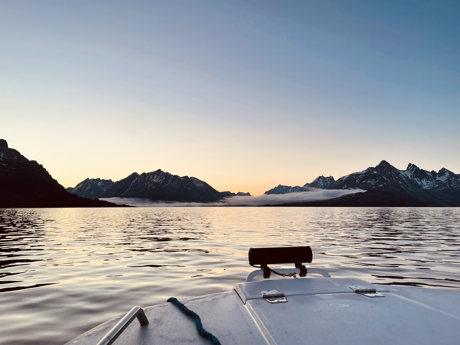 View of misty mountains from a boat in Greenland